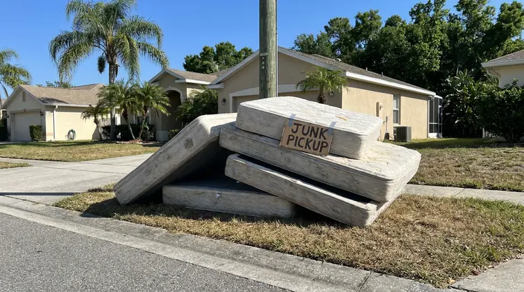 Mattresses and box springs staged for pickup near Orlando
